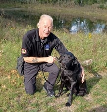 MSA Security Canine Handler and his canine, a black Labrador