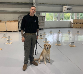 MSA Security Canine Trainer and Yellow Labrador at training site in Orangeburg, NY
